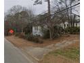 Modest home nestled among mature trees along a quiet street, set back from the road at 2010 Mcafee Pl, Decatur, GA 30032