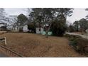 Cozy home featuring a screen porch, nestled among mature trees and a spacious front yard at 2010 Mcafee Pl, Decatur, GA 30032