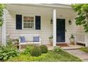 Cozy front porch with bench seating, beautiful plants and charming curb appeal at 3992 Camden Way, Alpharetta, GA 30005