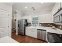 Bright kitchen features stainless steel appliances, white cabinets, and hardwood floors at 3992 Camden Way, Alpharetta, GA 30005