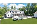 A beautiful backyard featuring a swimming pool, hot tub, screened porch, and lounging area at 604 Trinity Church Rd, Canton, GA 30115