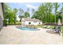 Backyard pool area with waterfall features and an adjacent pool house at 604 Trinity Church Rd, Canton, GA 30115