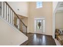 Bright foyer with gleaming hardwood floors, staircase, and natural light at 113 Osier Dr, Mcdonough, GA 30252