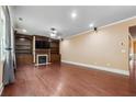Bright living room boasts hardwood floors, built-in bookshelves, and a cozy fireplace at 1340 Delo Ln, Cumming, GA 30041