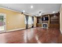 Spacious living room featuring hardwood floors, a fireplace, and built-in shelving at 1340 Delo Ln, Cumming, GA 30041