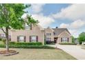 Attractive two-story brick home showcasing lush green lawn and mature trees in a desirable neighborhood at 4217 Brentwood Dr, Buford, GA 30518