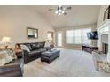 Inviting living room featuring a comfortable leather sofa, brick fireplace, and a wall-mounted television at 4217 Brentwood Dr, Buford, GA 30518
