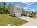 Exterior side view of a cozy home with a well-maintained lawn, a driveway, and an attached two-car garage at 3475 Ridge Hill Pkwy, Douglasville, GA 30135