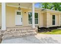 Inviting front entrance featuring brick steps and a classic white door, complemented by fresh landscaping at 4002 Lindsey Dr, Decatur, GA 30035