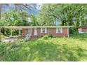 Charming single-story brick home with a covered porch and well-maintained front yard landscaping at 844 Oak Nw St, Atlanta, GA 30318