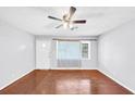 Empty living room featuring hardwood floors, a ceiling fan, and a front-facing window at 844 Oak Nw St, Atlanta, GA 30318