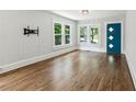 Bright living room with hardwood floors, large windows, and a stylish blue door offering modern charm at 308 Mcpherson Se Pl, Atlanta, GA 30316