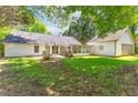 Expansive backyard featuring a screened porch and detached garage at 3335 Ashton Dr, Suwanee, GA 30024