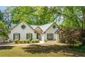 Charming home boasts manicured landscaping and classic architectural details at 3335 Ashton Dr, Suwanee, GA 30024
