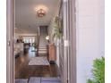 Inviting foyer featuring hardwood floors, a staircase, and a view into the open-concept living space at 3611 Ridgeway Rd, Duluth, GA 30096