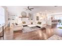 Bright living room with built-in shelving, fireplace, hardwood floors, and open flow to the kitchen at 3611 Ridgeway Rd, Duluth, GA 30096