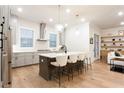 Stylish kitchen featuring a center island with seating, pendant lights, and modern appliances at 423 Burton Dr, Alpharetta, GA 30009