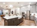Gourmet kitchen with island, stainless appliances, custom cabinets and farmhouse sink at 423 Burton Dr, Alpharetta, GA 30009