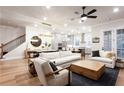 Bright, open-concept living room boasts hardwood floors, white sofas, and modern decor at 423 Burton Dr, Alpharetta, GA 30009