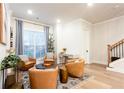 Cozy sitting area with four leather chairs, large window, and a rug on hardwood floors at 423 Burton Dr, Alpharetta, GA 30009
