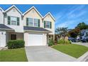 Two-story townhome featuring a one-car garage and a well-maintained lawn at 6918 Gallant Se Cir # 22, Mableton, GA 30126