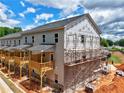 Exterior view of new townhomes under construction, showcasing balconies and brick facade at 2 Rock Park Way # 13, Tucker, GA 30084