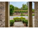 Inviting view from the front porch, showcasing a well-maintained street, lush greenery, and a glimpse of the neighborhood at 385 Windy Pines Trl, Roswell, GA 30075
