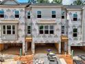 Exterior construction on new homes showing garages, windows, and Kingspan GreenGuard building supplies at 4 Rock Park Way # 14, Tucker, GA 30084