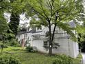 Charming two-story home with brick and white painted siding and landscaped yard at 55 Beverly Ne Rd, Atlanta, GA 30309