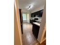 Kitchen features black cabinets, stainless steel appliances, and a sunny window at 6449 Pinebark Way, Morrow, GA 30260