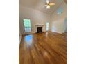 Spacious living room features beautiful hardwood floors and a cozy fireplace at 6449 Pinebark Way, Morrow, GA 30260