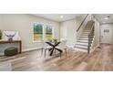 Stylish dining room with modern table, wood floors, and plenty of natural light at 1330 Adams Sw Dr, Atlanta, GA 30311