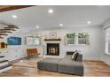 Comfortable living room with a cozy fireplace, hardwood floors, and abundant natural light from the large windows at 2705 Osborne Ne Rd, Brookhaven, GA 30319