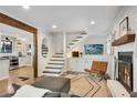 Inviting living room featuring a fireplace, hardwood floors, seamlessly connecting to the kitchen and staircase at 2705 Osborne Ne Rd, Brookhaven, GA 30319