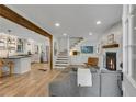 Open-concept living room featuring a fireplace, hardwood floors, and seamless flow into the modern kitchen at 2705 Osborne Ne Rd, Brookhaven, GA 30319