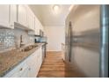 Stylish kitchen with stainless steel appliances, granite countertops, and gray subway tile backsplash at 6082 Raintree Bnd, Lithonia, GA 30058