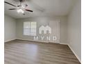 Bright living room featuring modern flooring, a ceiling fan and a window letting in lots of natural light at 119 Michelle Dr, Mcdonough, GA 30252