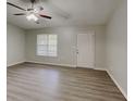 Bright living room with new laminate flooring, a ceiling fan, and a window to let in natural light at 119 Michelle Dr, Mcdonough, GA 30252