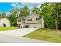 Charming split-level home with a two-car garage and a well-maintained lawn at 236 Fairview Dr, Dallas, GA 30157