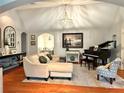 Bright living room featuring hardwood floors, neutral furniture, and a grand piano at 3014 Echols Rd, Cumming, GA 30041