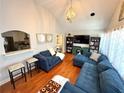 Spacious living room features hardwood floors, blue sofa, and open layout to kitchen at 3014 Echols Rd, Cumming, GA 30041