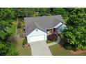 Charming single-Gathering home with manicured lawn, two car garage, and mature trees surrounding the property at 5298 Autumn Run Dr, Powder Springs, GA 30127