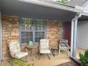 Cozy front porch featuring stone accents, comfortable seating, and a tranquil spot to enjoy the outdoors at 5298 Autumn Run Dr, Powder Springs, GA 30127