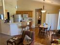 Bright kitchen featuring wooden cabinets, a breakfast bar with seating, and an adjacent dining area at 5298 Autumn Run Dr, Powder Springs, GA 30127