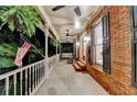 Relaxing covered porch with ceiling fans, rocking chair, and swing for outdoor enjoyment at 5335 Bannergate Dr, Johns Creek, GA 30022