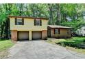 Charming two-story home with brick and siding, a two-car garage, and mature trees at 6419 Danbury Ln, Norcross, GA 30093