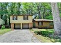 Charming two-story home with brick and siding, a two-car garage, and mature trees at 6419 Danbury Ln, Norcross, GA 30093