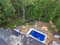 Bird's eye view of the home with a rectangular pool, a fire pit and mature trees in the landscaped backyard at 1125 Murray Sw Cir, Marietta, GA 30064