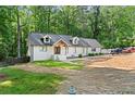 Ranch-style home featuring a crisp white painted brick exterior with modern windows and manicured landscaping at 1125 Murray Sw Cir, Marietta, GA 30064
