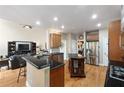 Modern kitchen with granite countertops, stainless steel appliances, and center island seating at 417 Rhodes House Dr, Suwanee, GA 30024